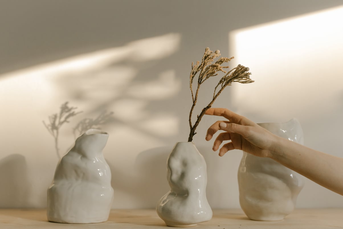 Person touching an Ornament in a Ceramic Figurine